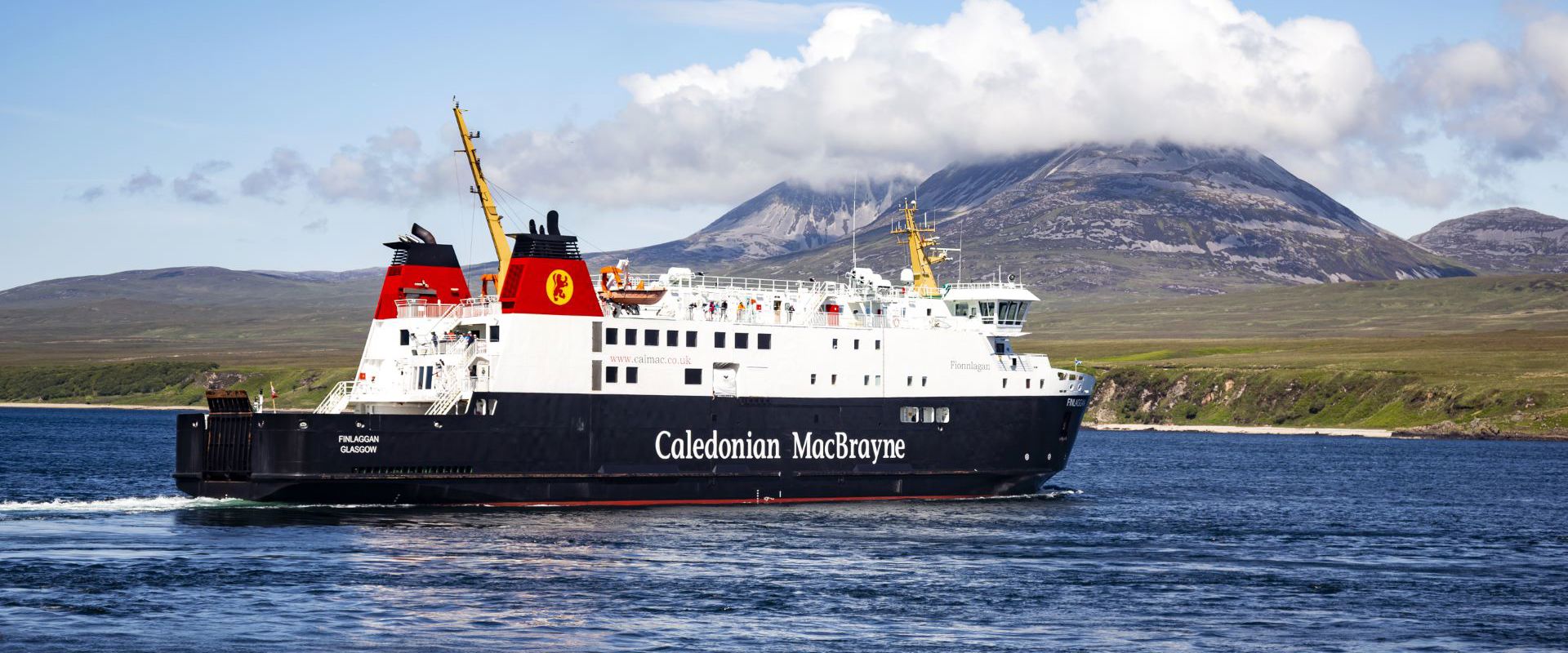 Caledonian MacBrayne ferry to and from Islay called MV Finlaggan, sailing with the cloud covered "Paps of Jura" in the background.
